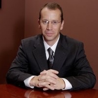 A person wearing a suit and tie

Description automatically generated